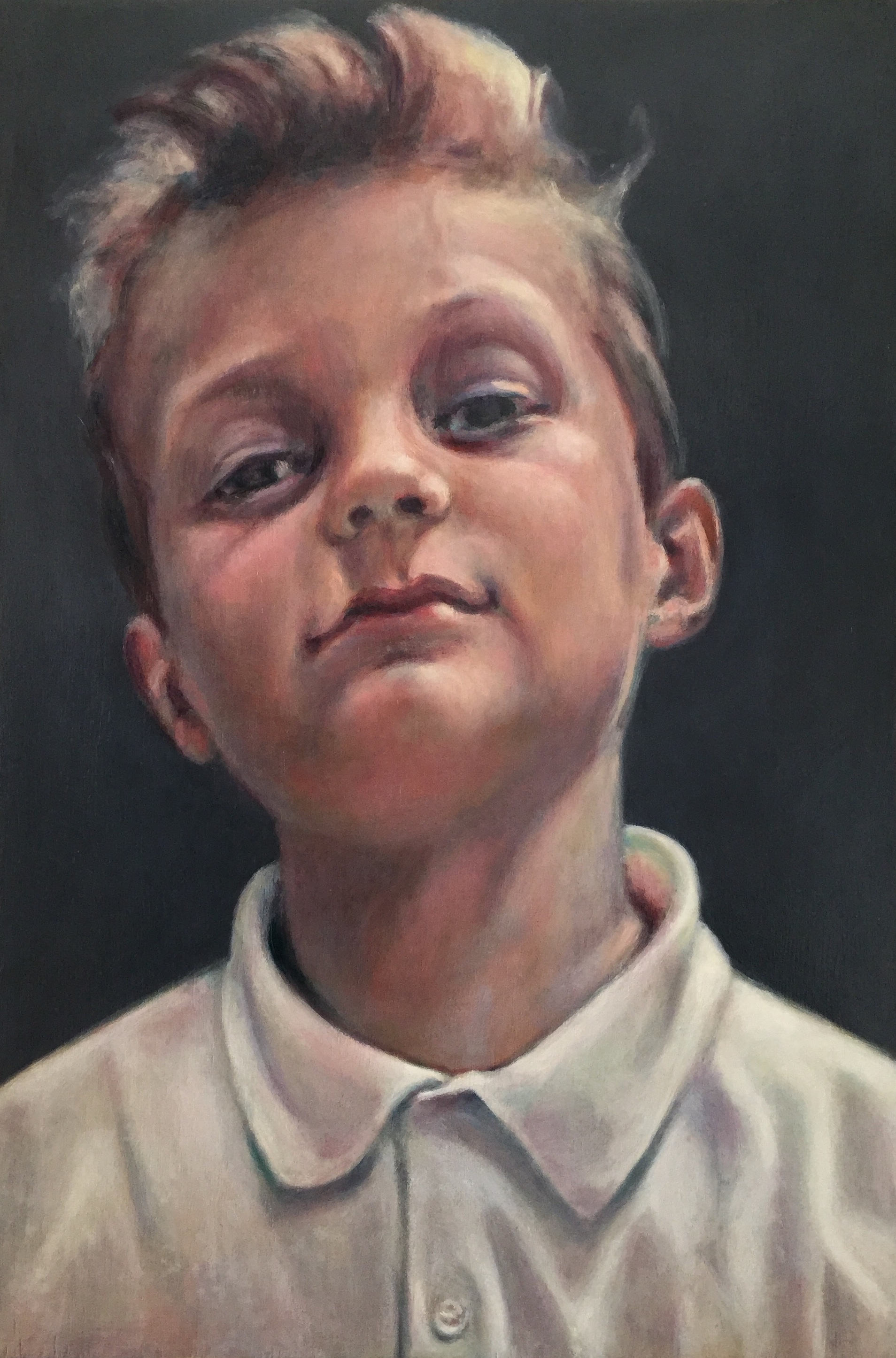 Portrait of 9 year old boy in a school polo-shirt. He's got some attitude!